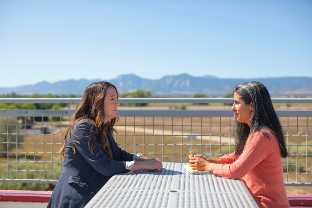 Samantha sitting at table with friend